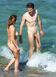 Sexy naked teens play together at a public beach